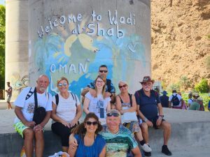 A group of people posing for a photo in Wadi Shab